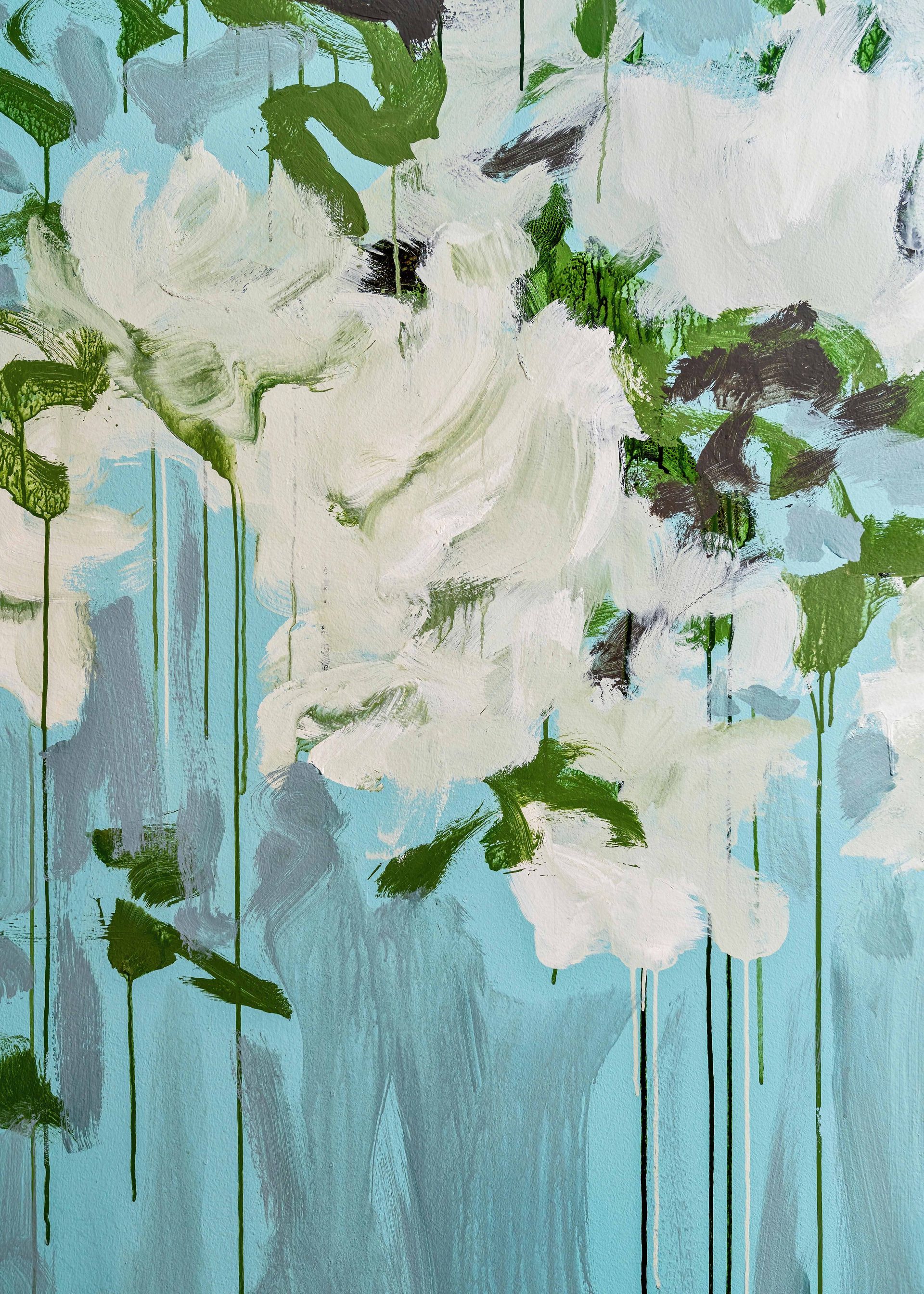 White flowers with green leaves on a pale blue painted background