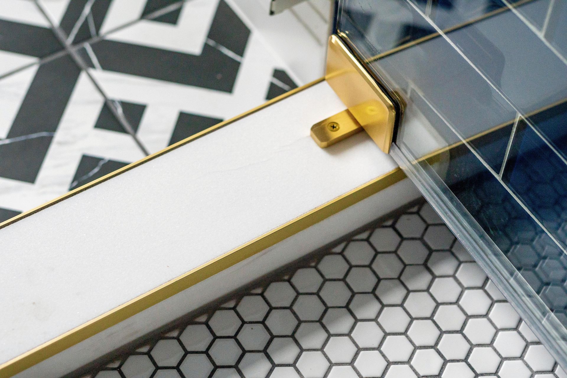 White-and-gold pen next to a blue notebook on a patterned desk surface