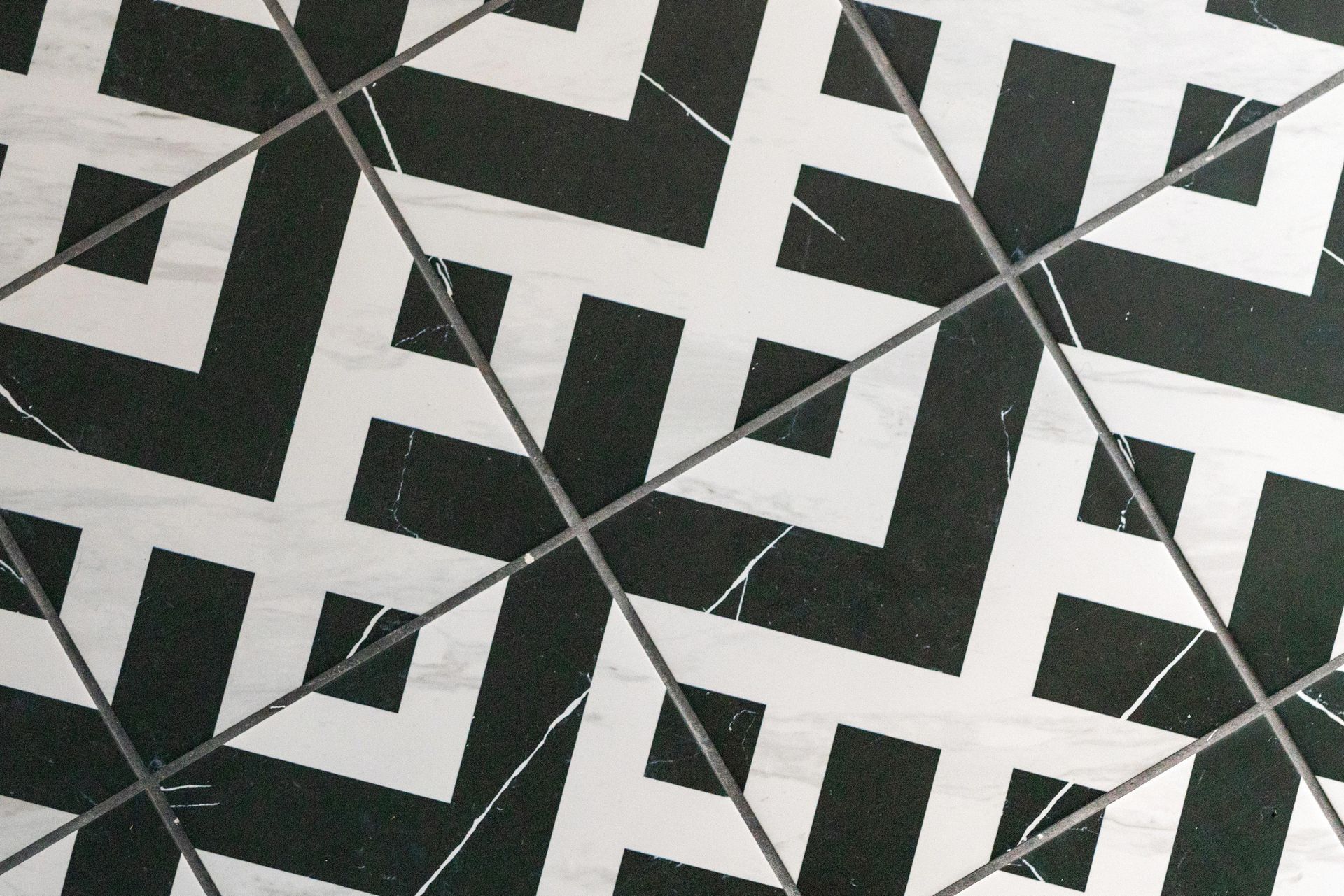 Black-and-white geometric tile pattern with repeating squares and diamonds