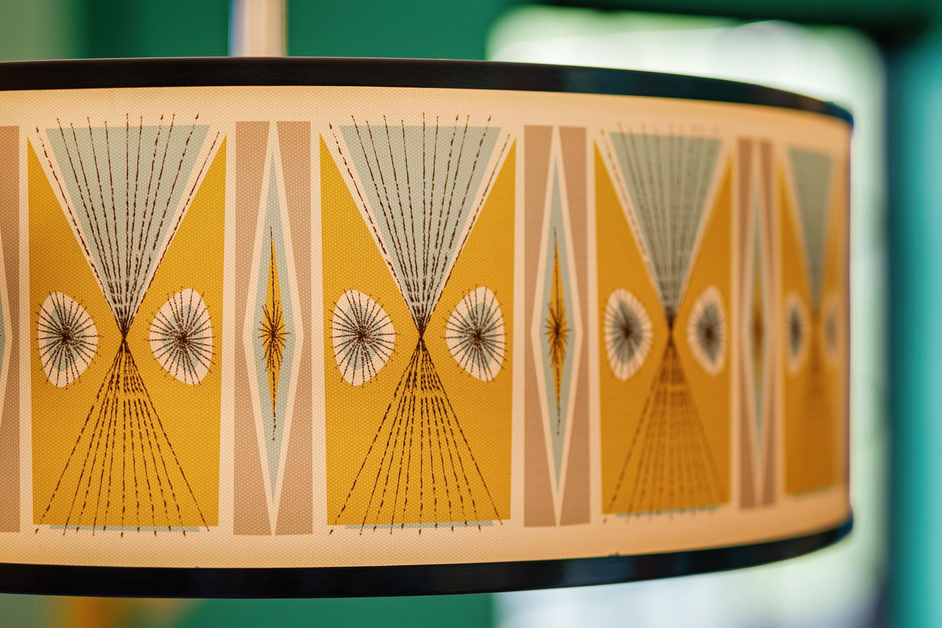 Colorful geometric patterned lampshade with yellow, orange, and teal accents
