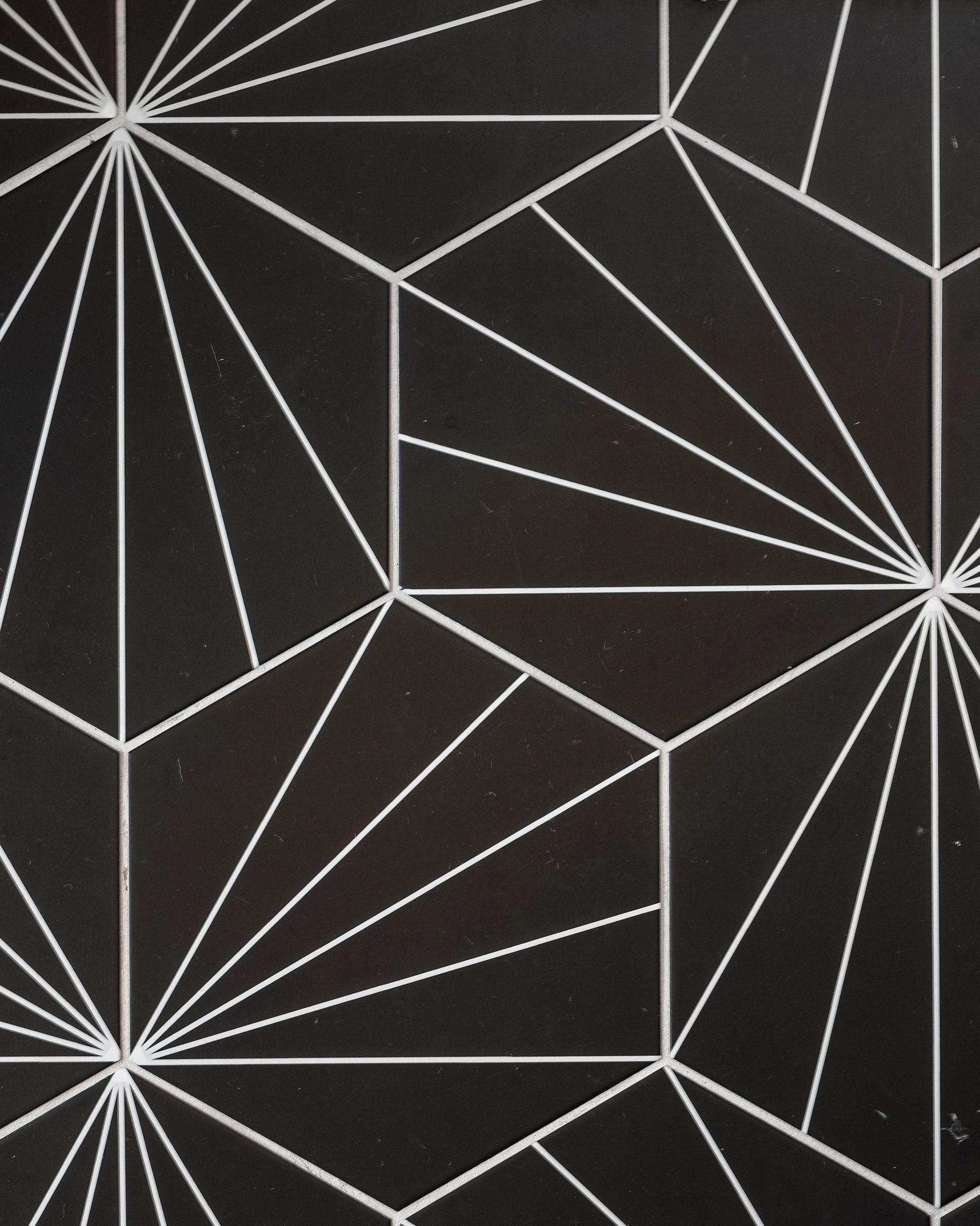 Abstract black wallpaper with white geometric line patterns and starburst corners