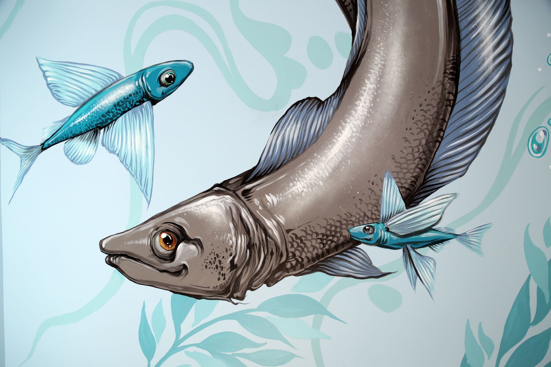 Stylized fish in blue-gray tones swimming among pale teal leaves on a light background