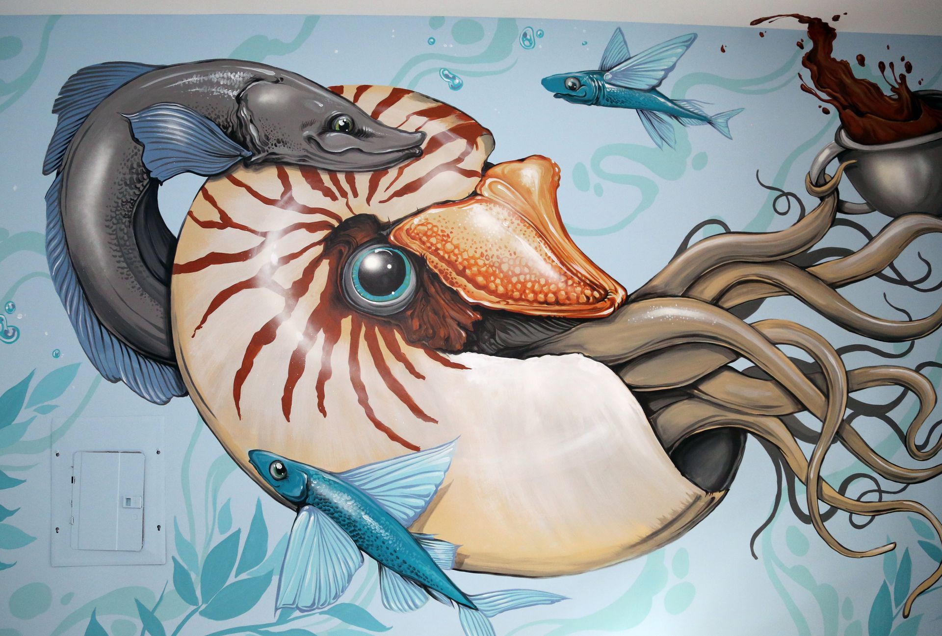 Illustrated nautilus with tentacles and fish in blue ocean-themed artwork