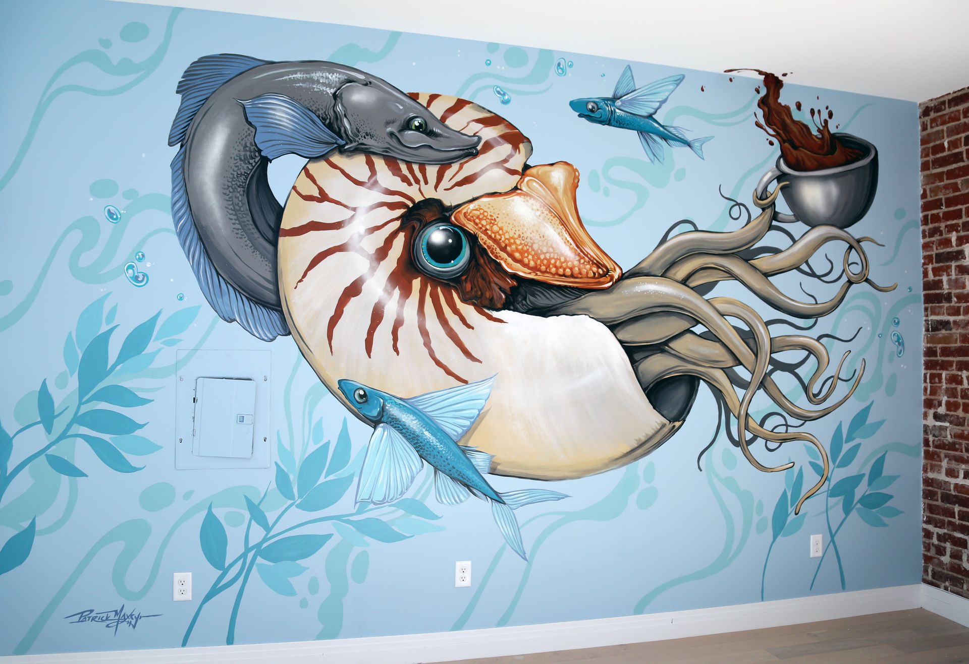 Large mural of a giant seashell, tentacles, and a shark on a blue wall