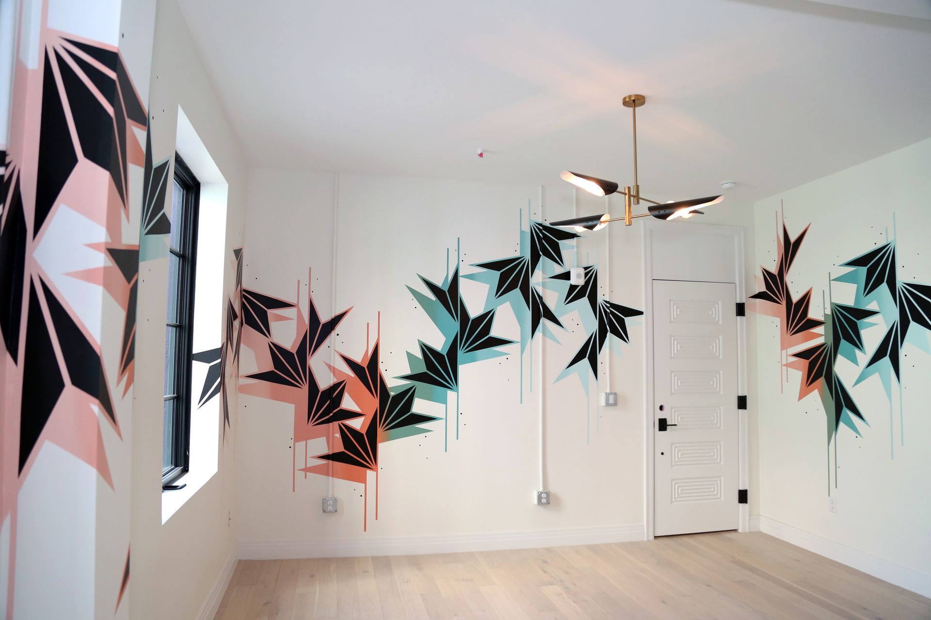 Modern room with colorful hanging bird sculptures and wall art in a bright minimalist interior