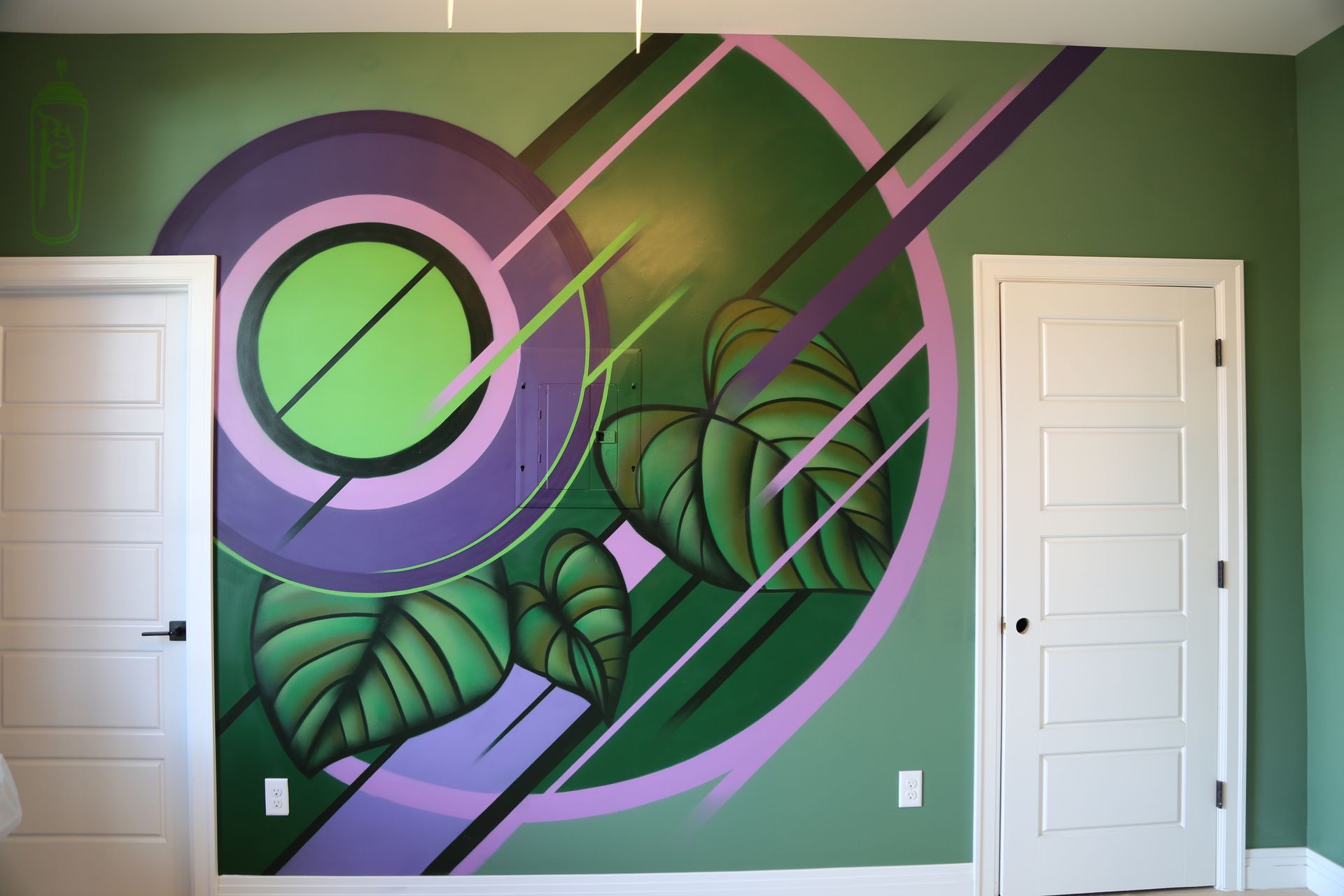 Abstract green mural with leaves, a pink circle, and diagonal stripes on a wall between two white doors