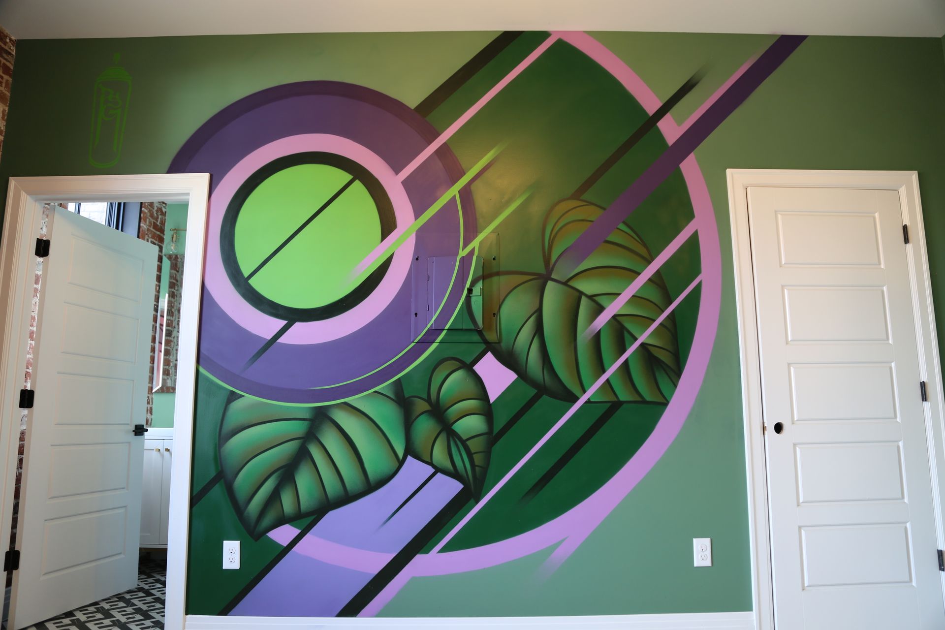 Green wall mural with purple circles and black diagonal stripes, flanked by two white doors.