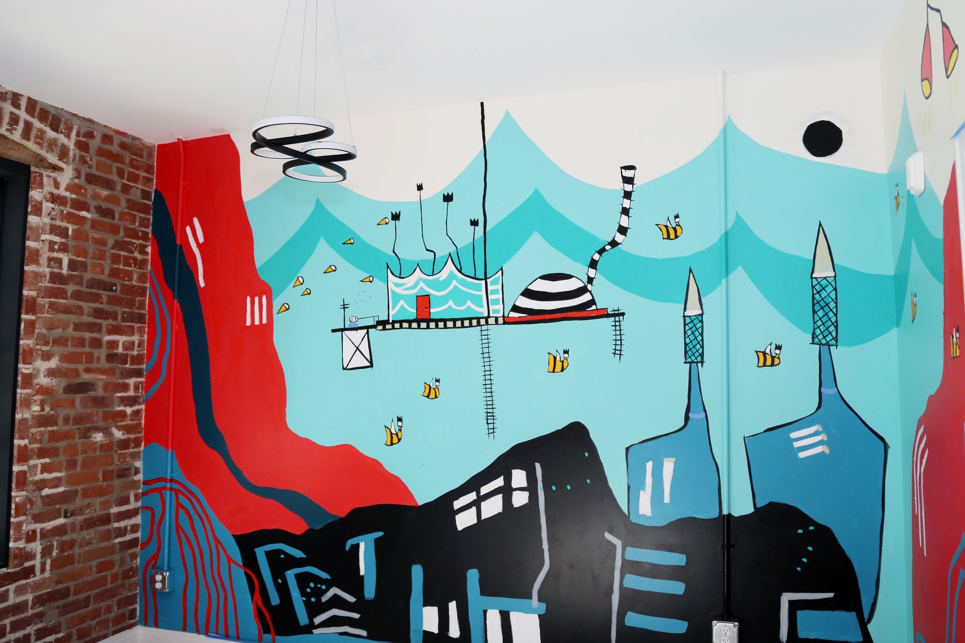 Colorful mural of a cityscape with blue mountains, red waterfall, black buildings, and hanging cable cars