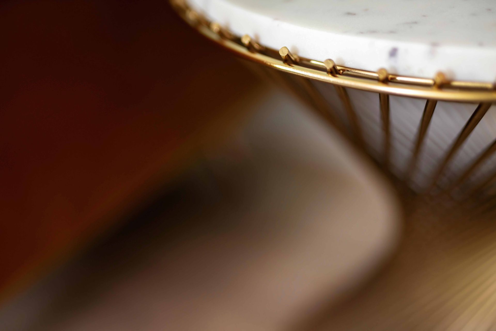 Close-up of a white and gold metal lampshade with warm blurred light
