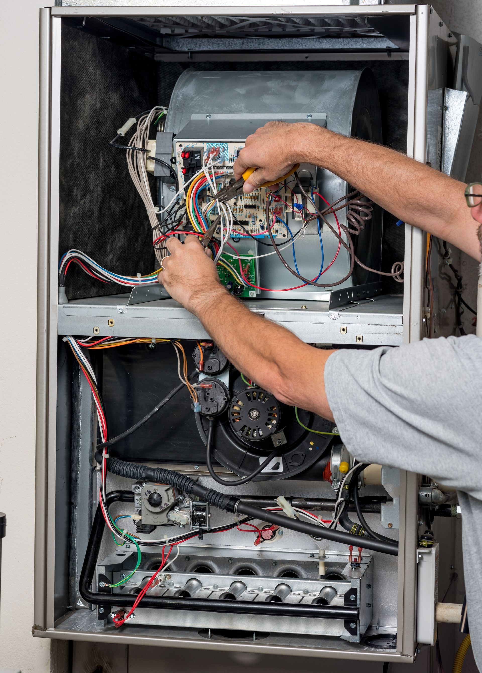 Heating system technician repairing heater system in Spokane