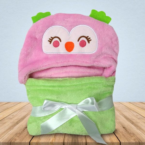 Een roze en groene deken met een uil erop