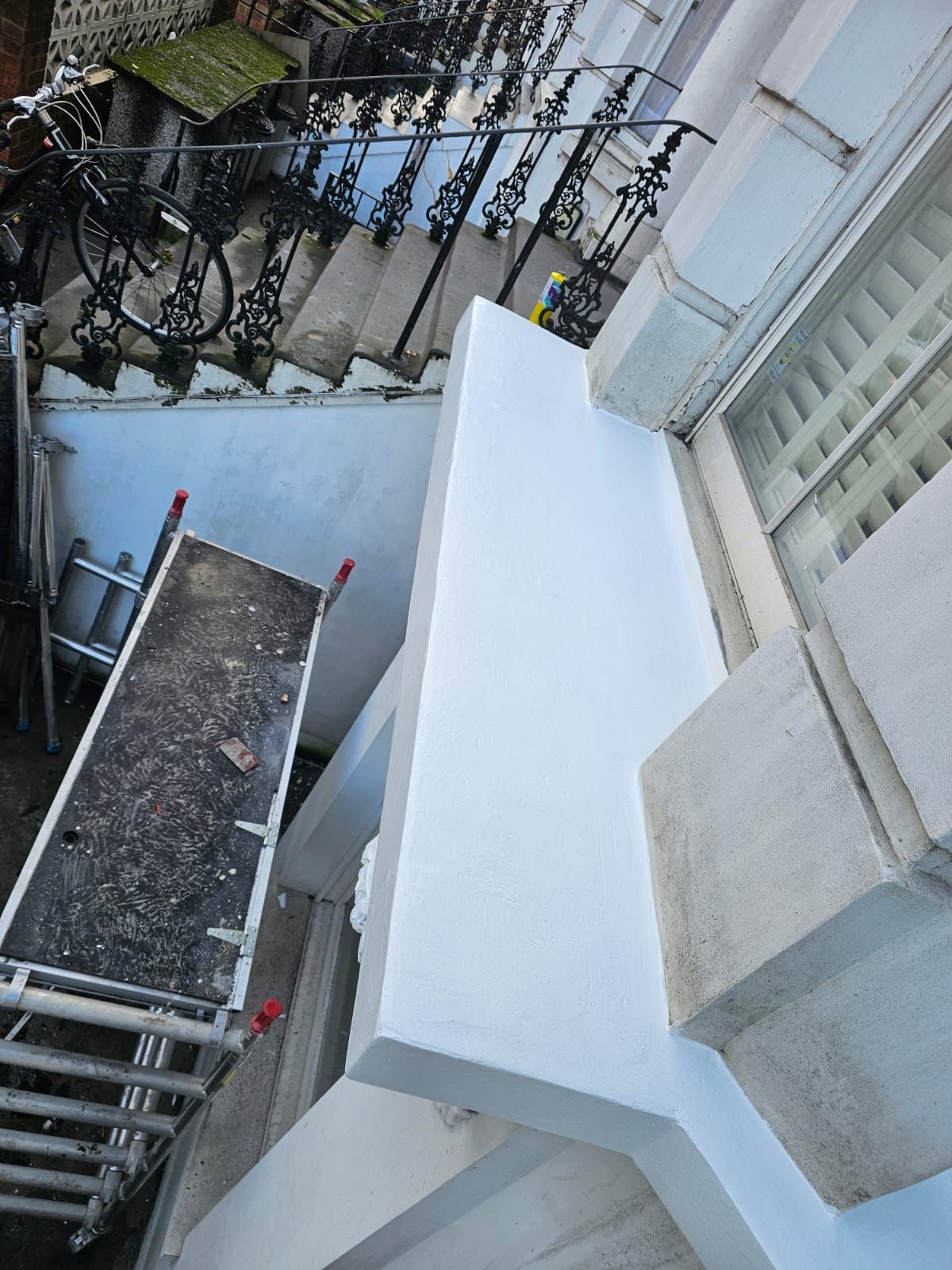 Exterior repair and painting of window board in North London