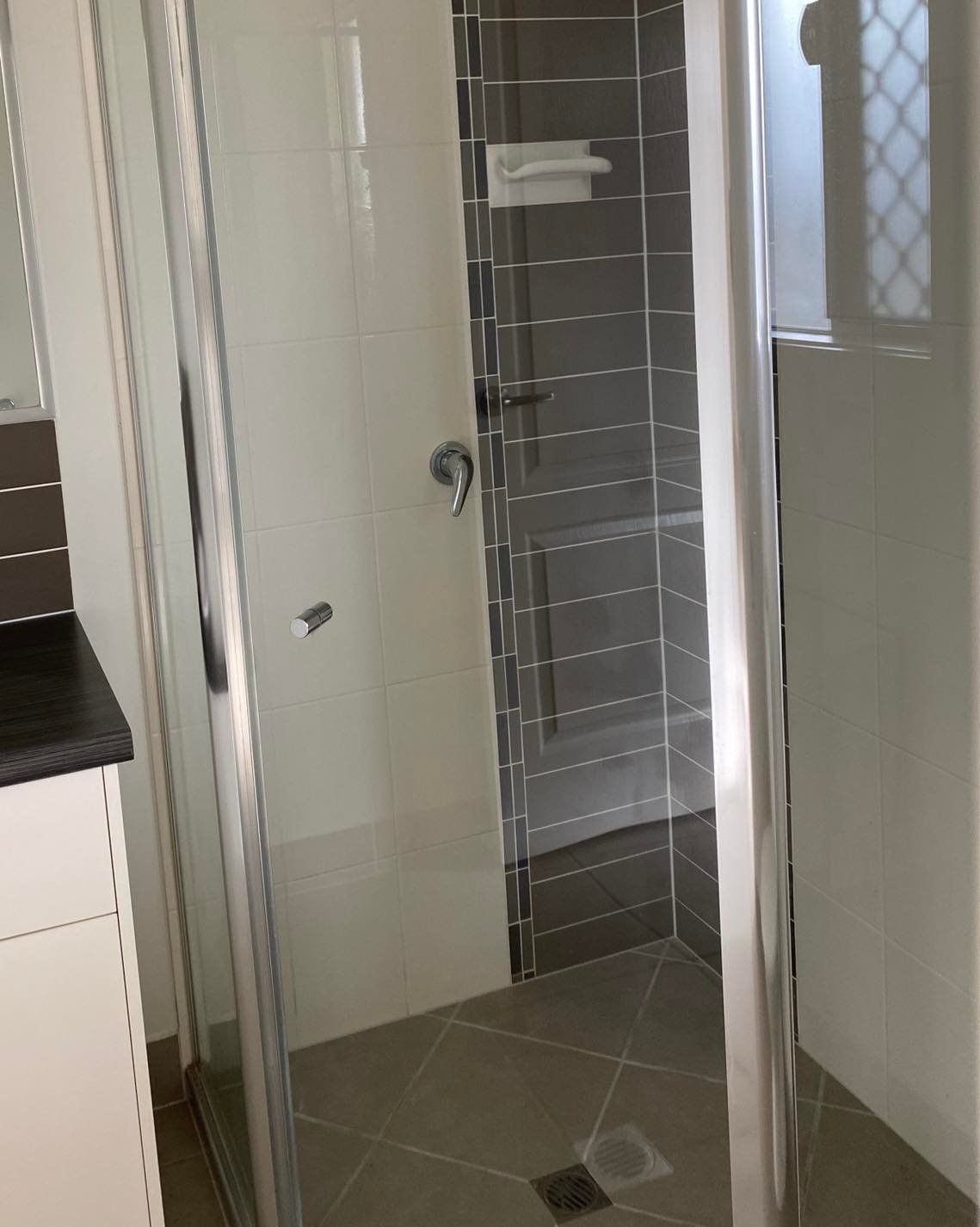 A Bathroom With a Walk in Shower and a Sink — Dawsons Cleaning Specialist In Mount Louisa, QLD