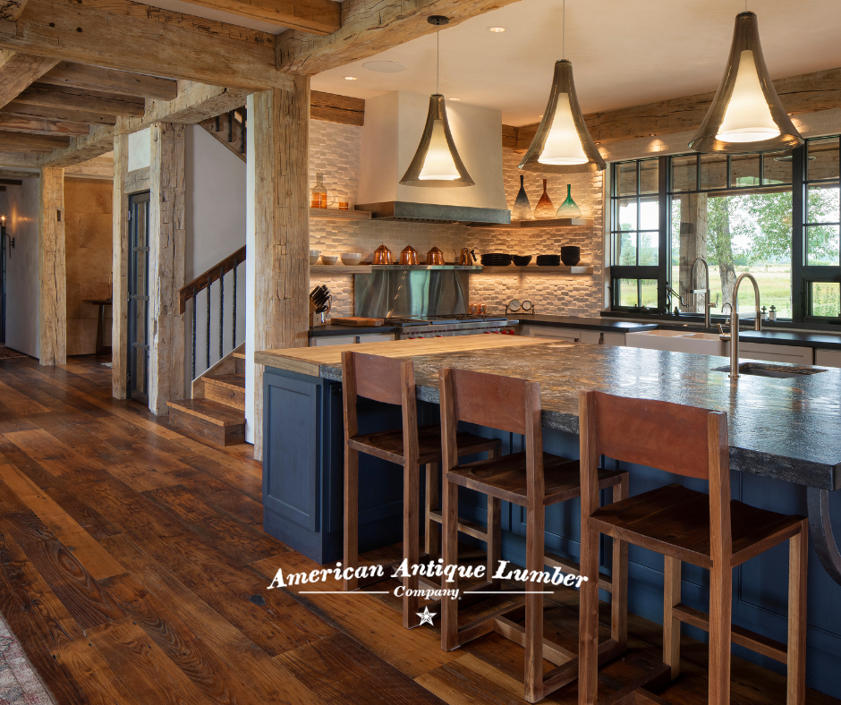 Blue center island in kitchen with wood floors.