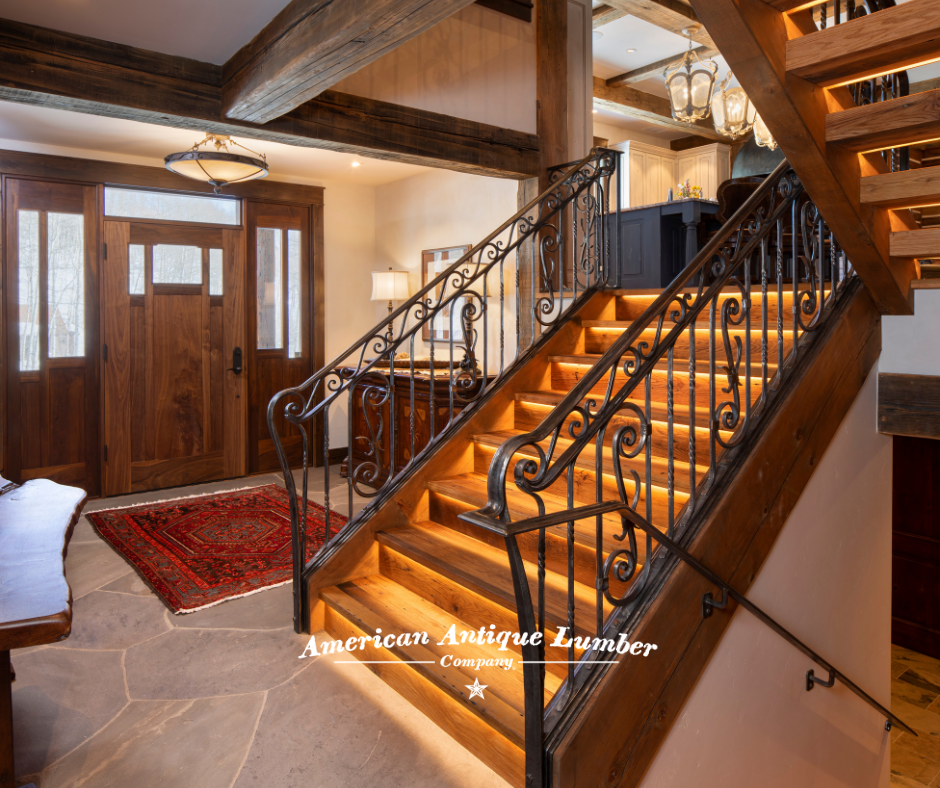 Wooden stair case with decorative wrought iron banister and stair riser lights.