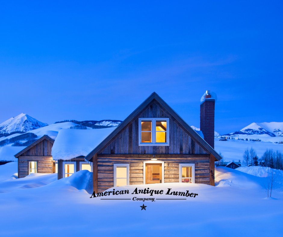 Reclaimed Hand Hen sided cabin at dusk buried in snow outside of Crested Butte, Colorado. 