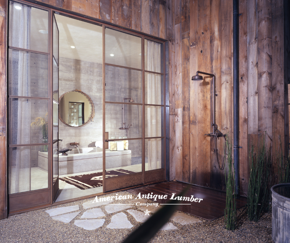 Glass door and wall leading into a stone bathroom with an outdoor shower on the right in Napa Valley, California. 