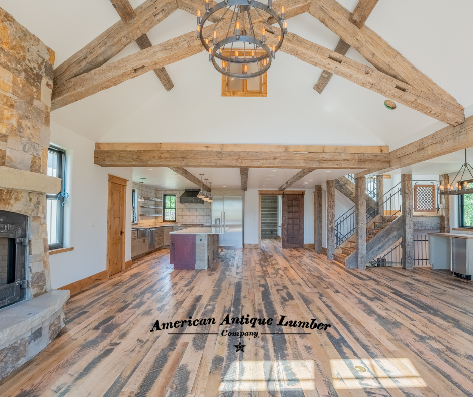 Wooden black and brown floors, red kitchen island with reclaimed hand hewn trusses. 