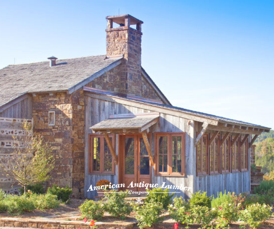Exterior of a sunroom with grey siding and brown wooden window and door trim.