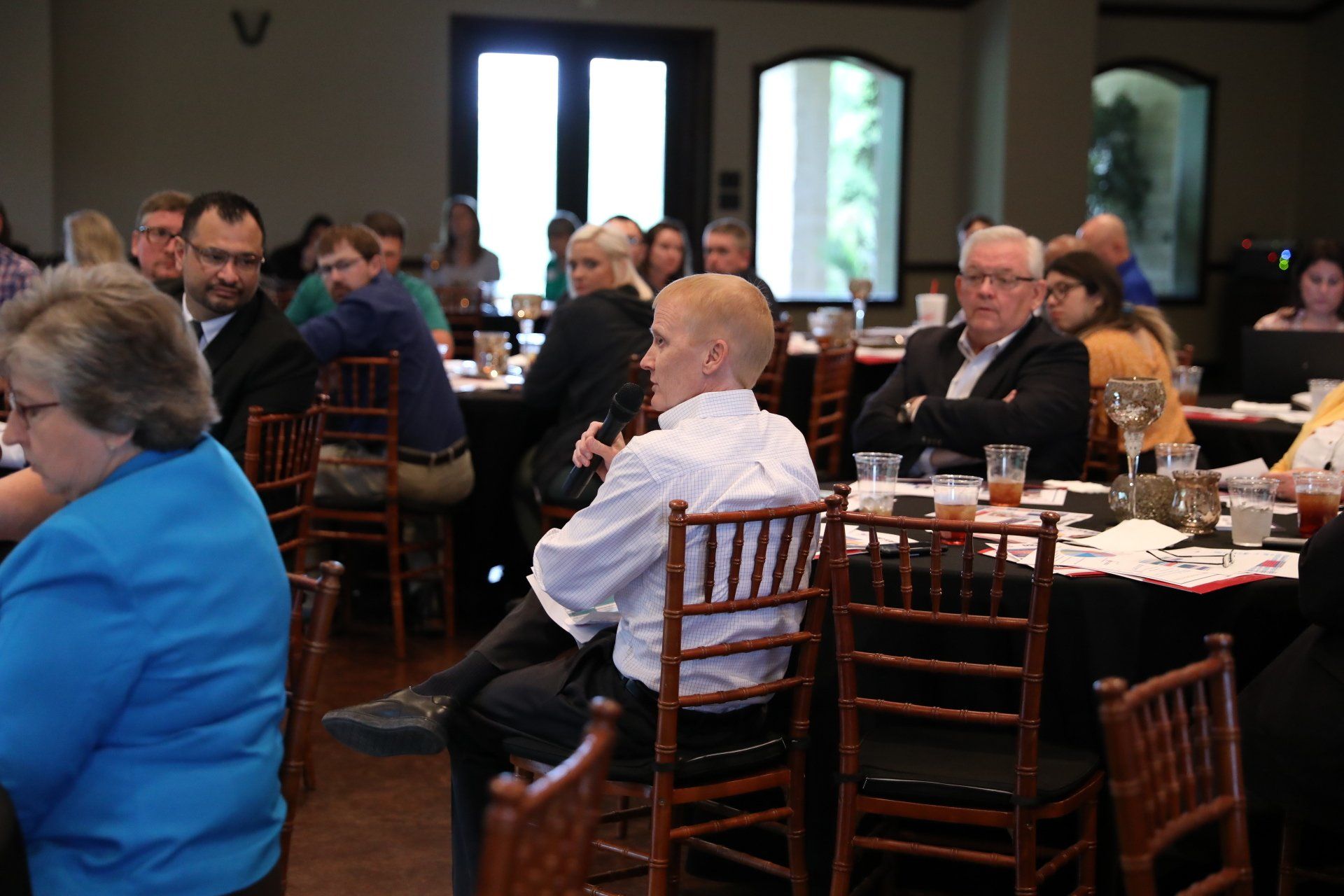 A group of people are sitting at tables in a restaurant