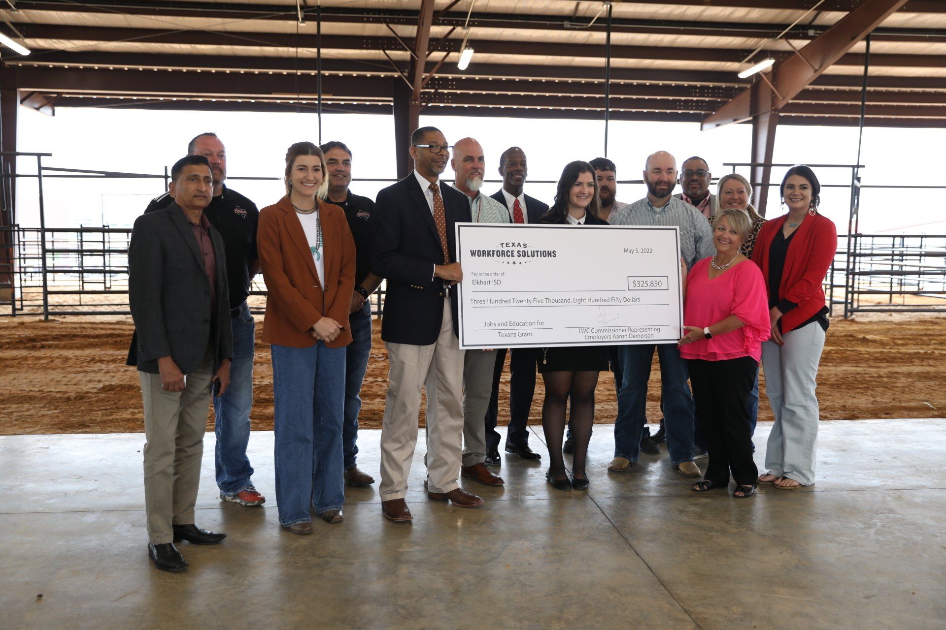 A group of people standing around a large check