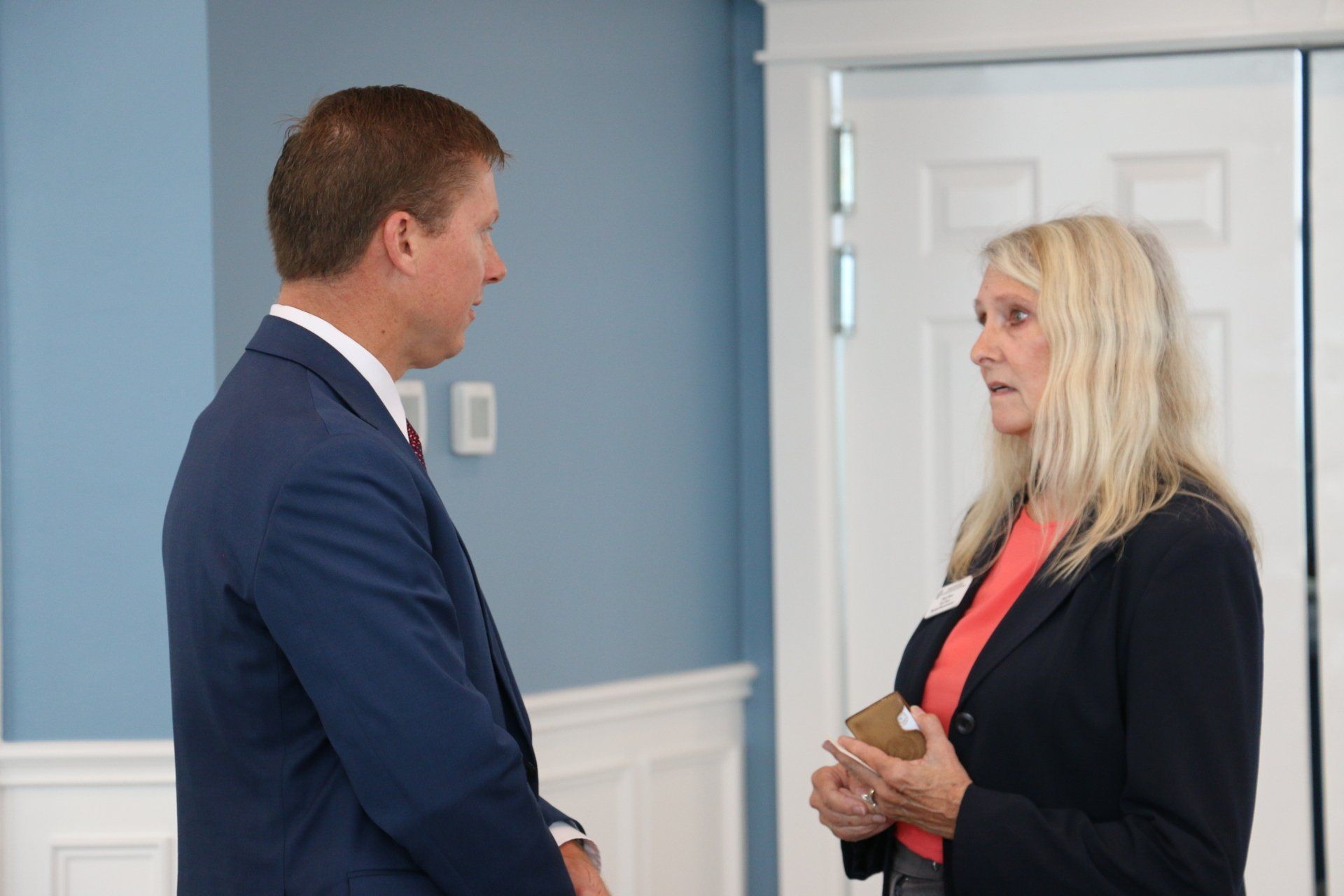 A man and a woman are talking to each other in a room.