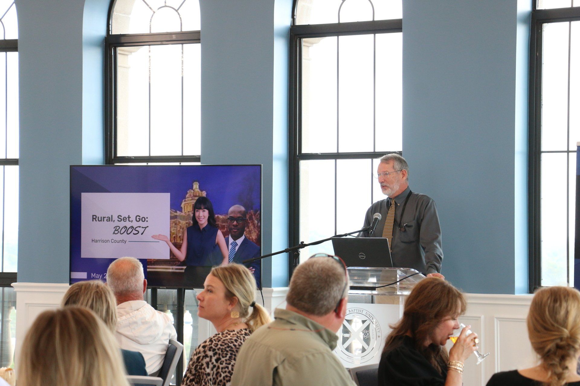 A man is giving a presentation to a group of people in a room.