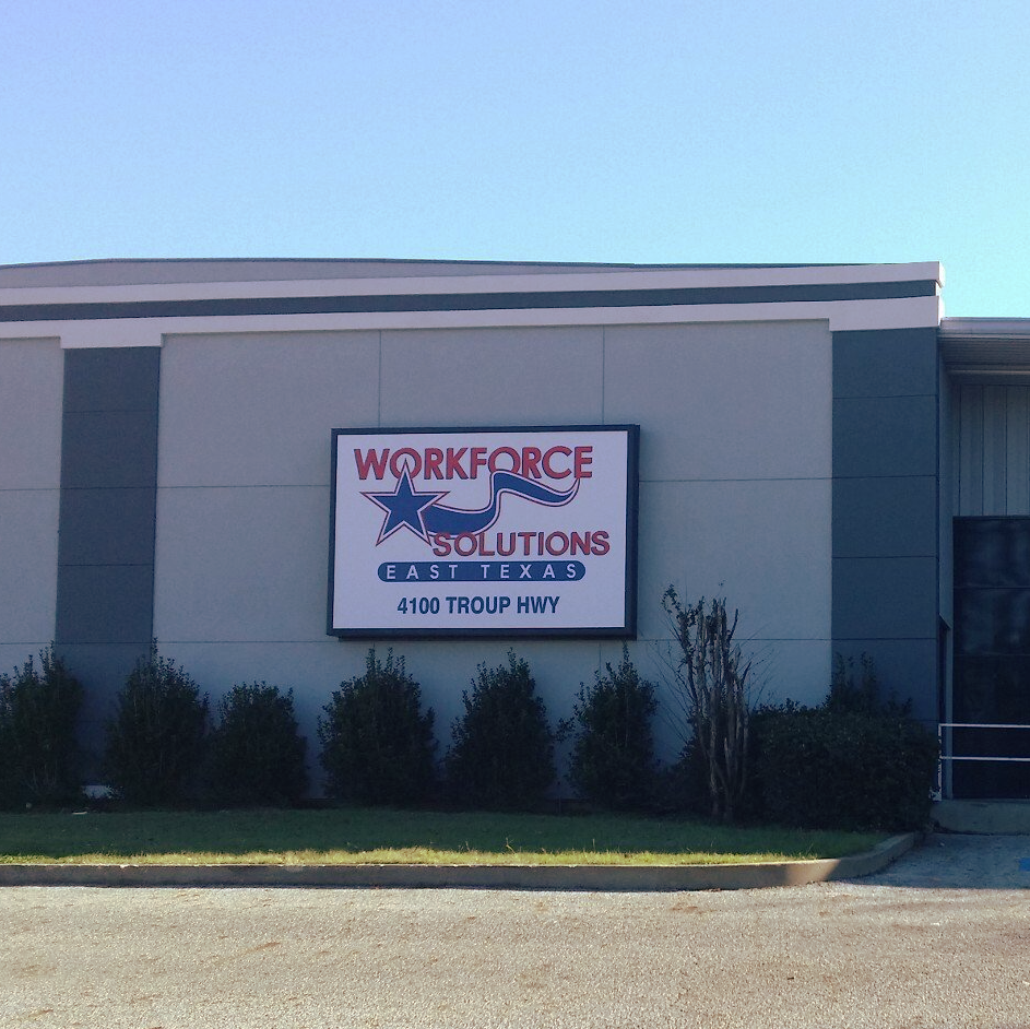 A sign on the side of a building that says workforce solutions