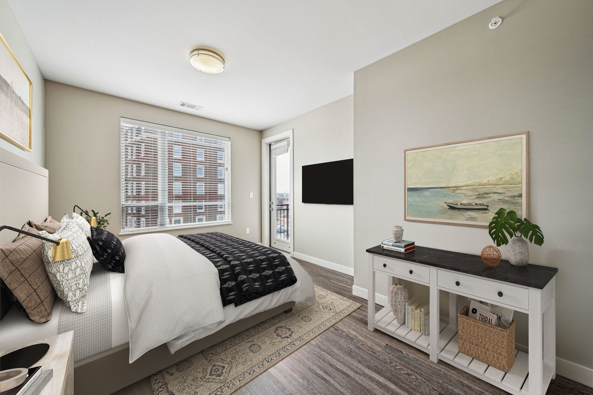 Bedroom in a modern apartment with bed, dresser, and balcony door at Chroma, offers apartments in St. Louis, MO.