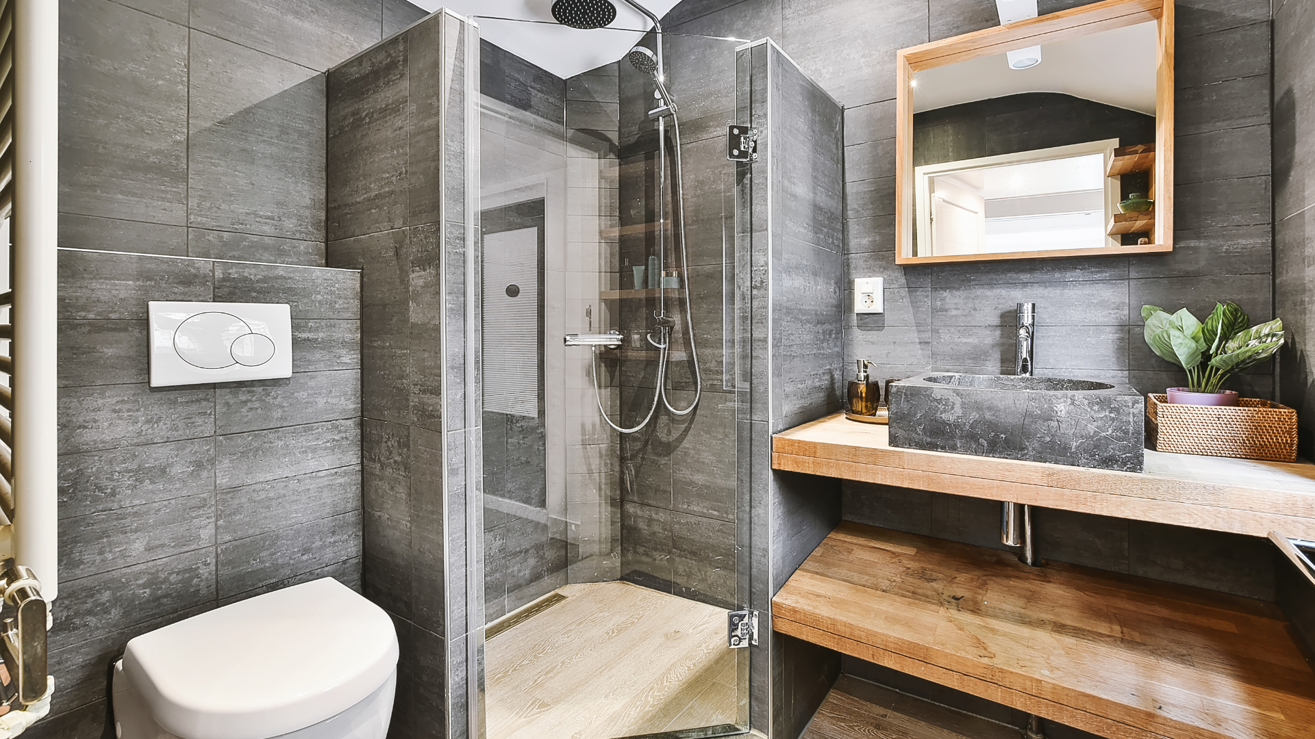 a bathroom with a toilet , sink , shower and mirror .