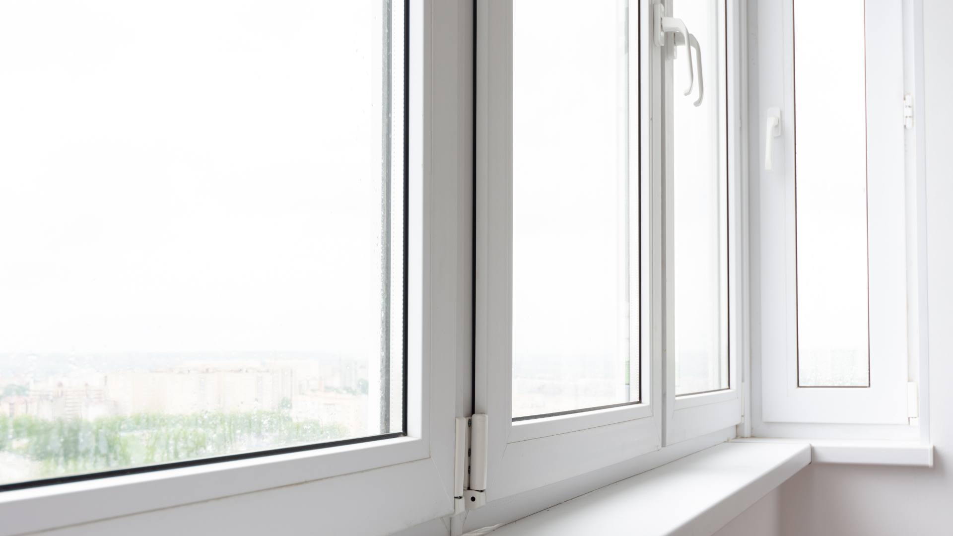 a close up of a white window with a view of a city .