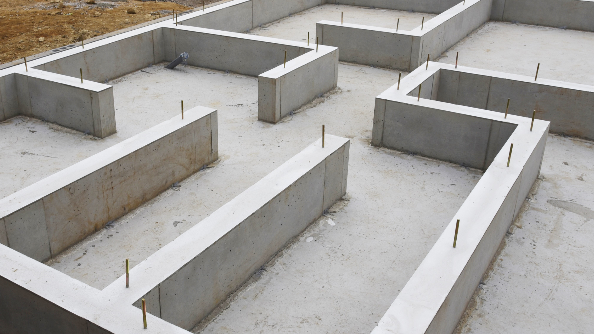 A concrete foundation for a house is being built.