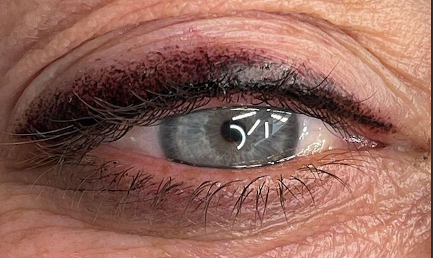A close up of a woman 's eye with makeup on it.