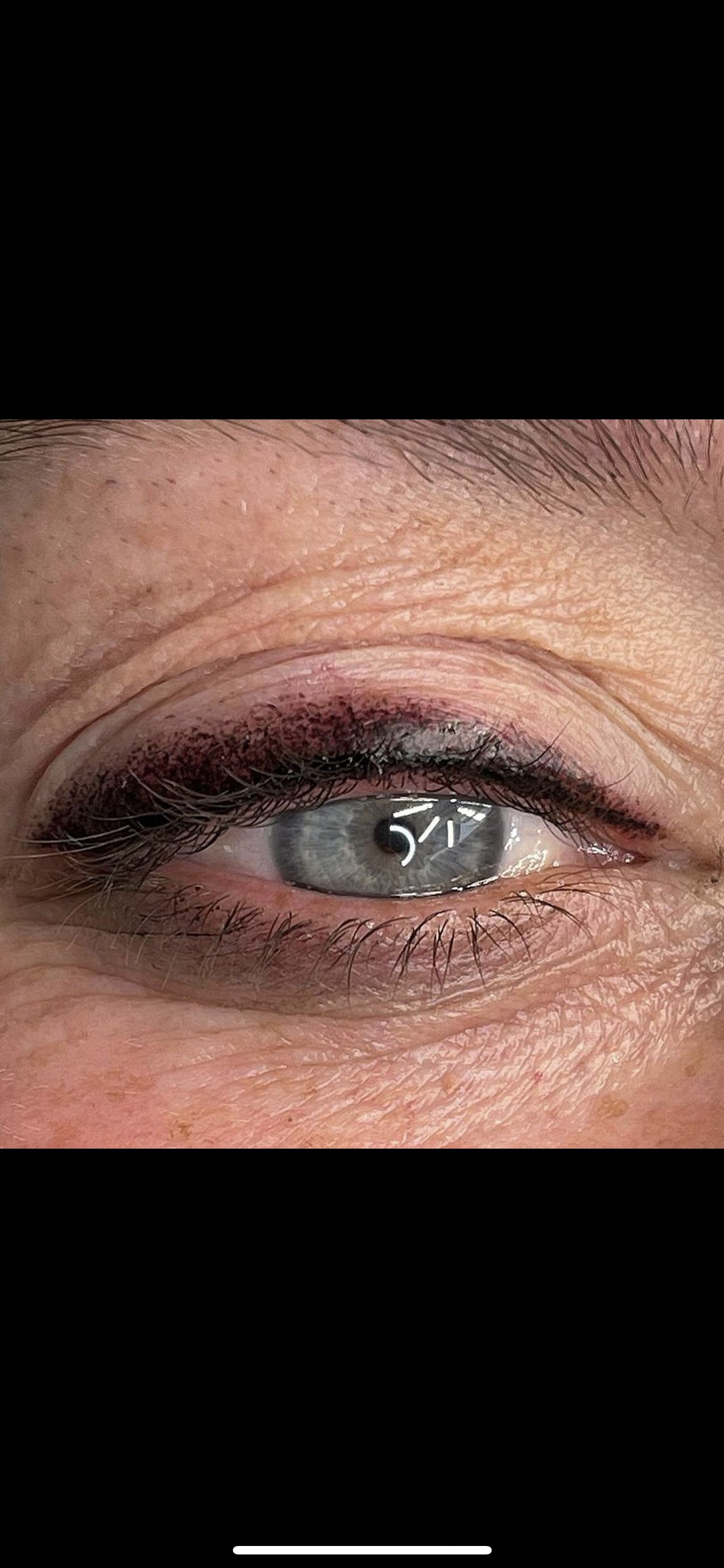 A close up of a woman 's eye with eyeliner.