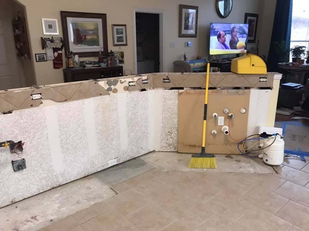 A broom is sitting on the floor in a living room.