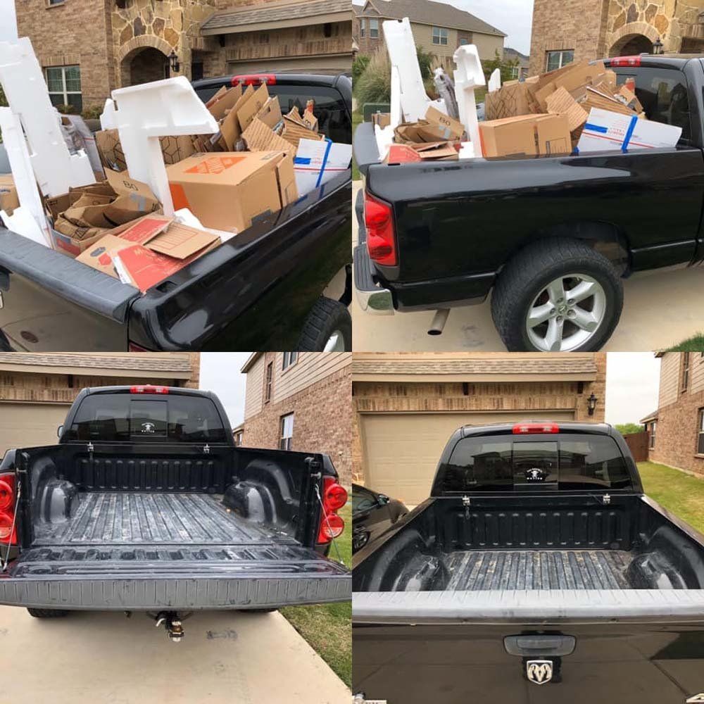 A black truck with boxes in the back is parked in front of a house.