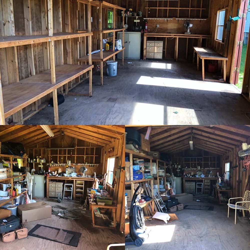 The inside of a wooden shed with shelves and a vacuum cleaner