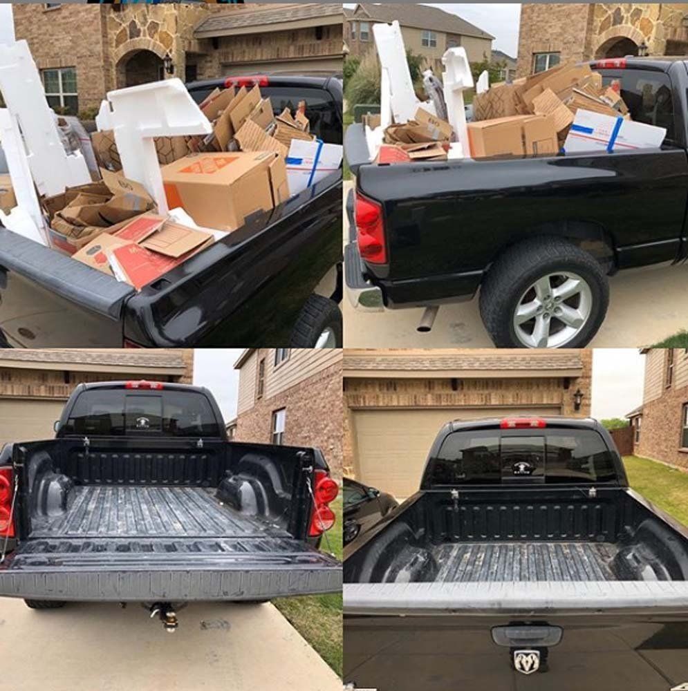 A black truck with boxes in the back is parked in front of a house.