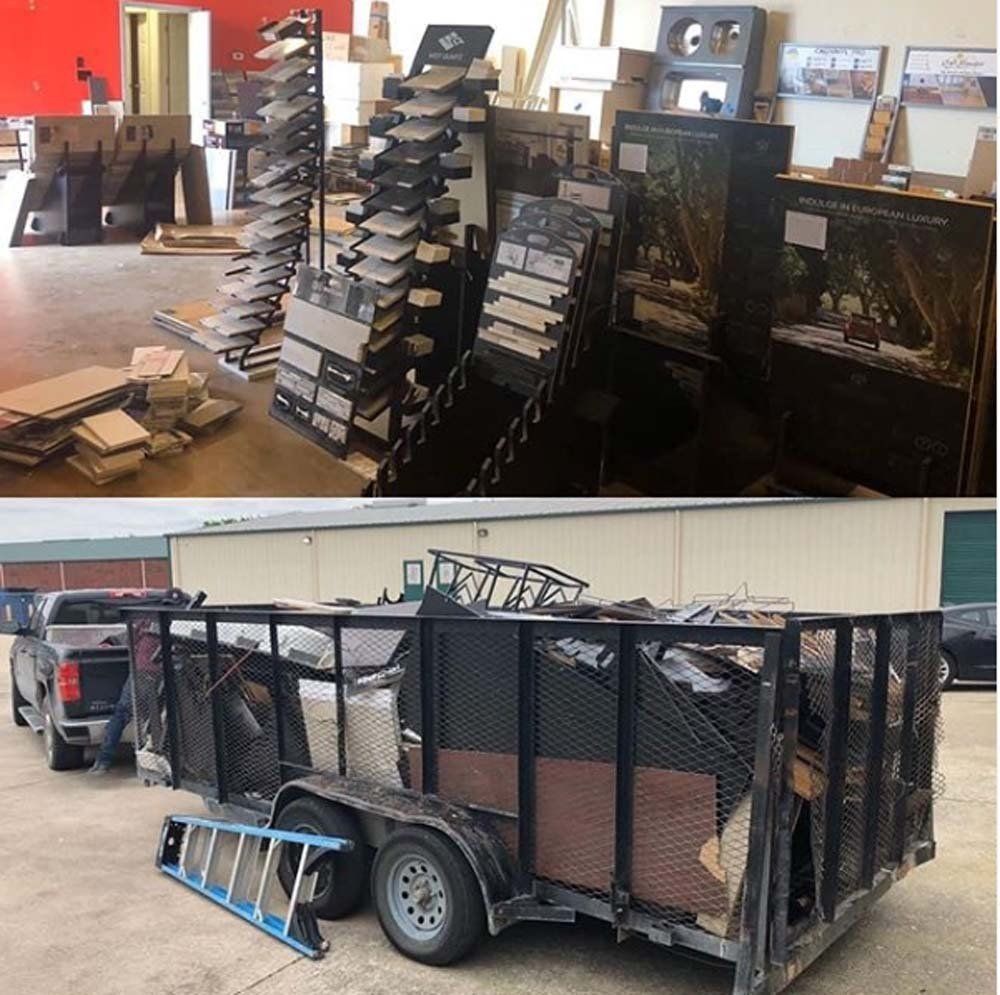 A trailer with a ladder attached to it is parked in front of a store