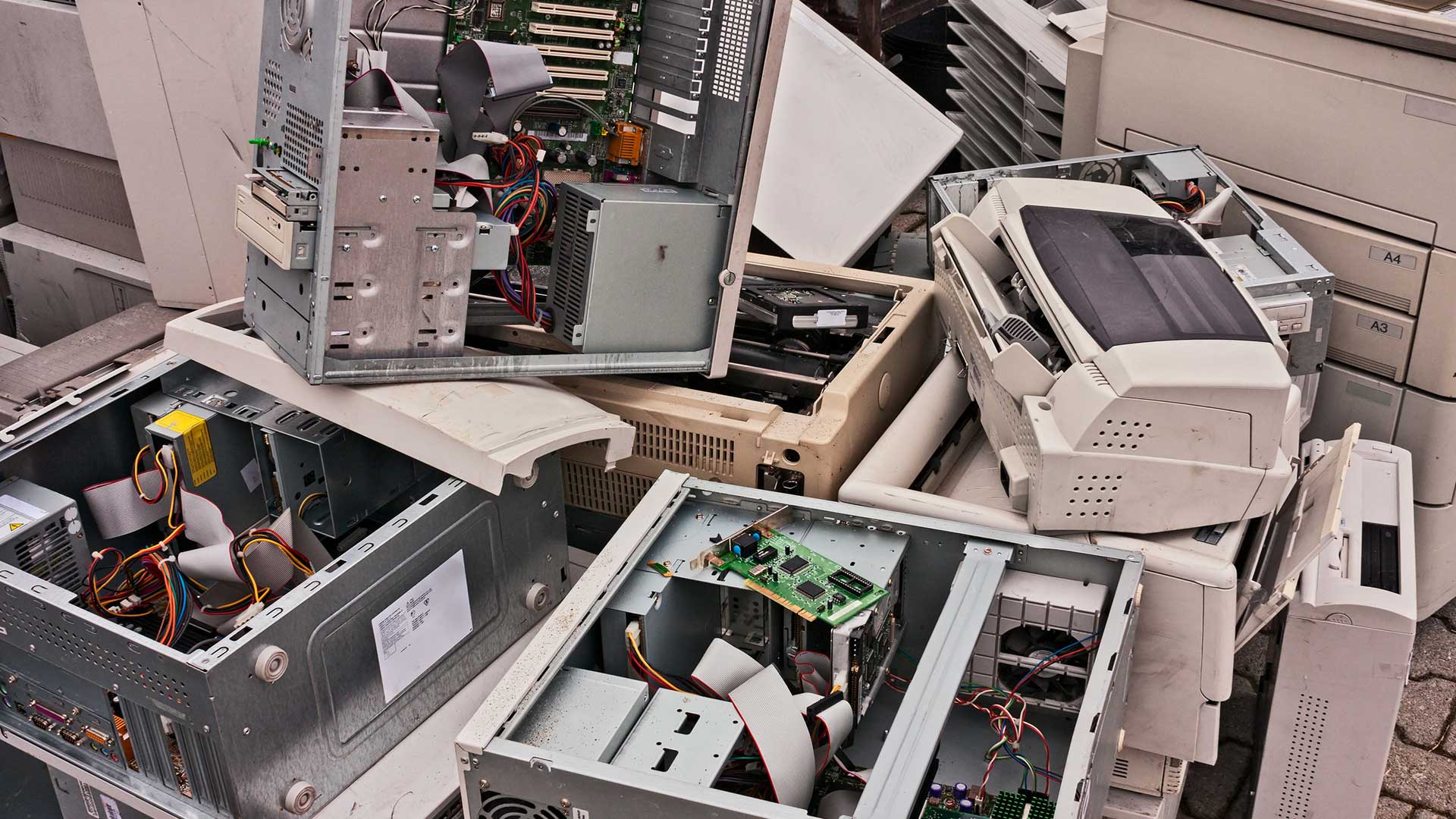 A pile of old computer parts including a printer