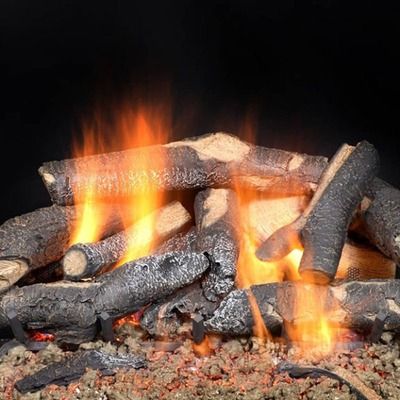 A stack of artificial ceramic logs burning with bright orange flames over glowing embers against a dark background.