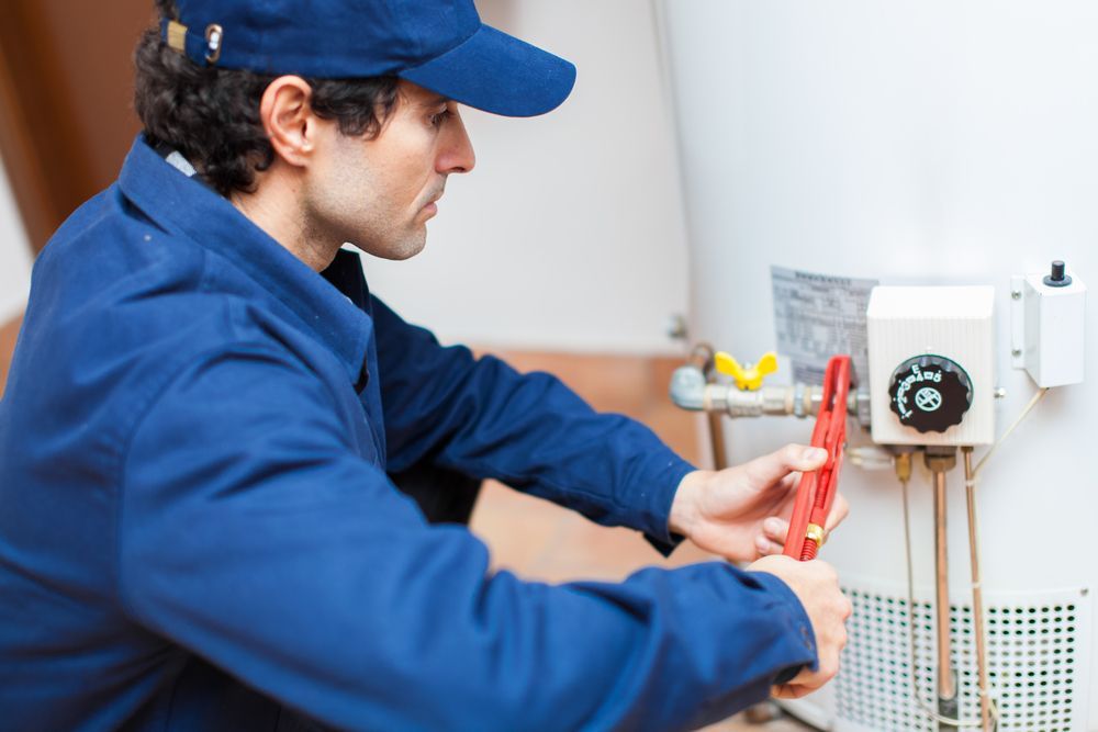 Plumber Fixing Hot Water Heater — Your Local Plumber in Armidale, NSW