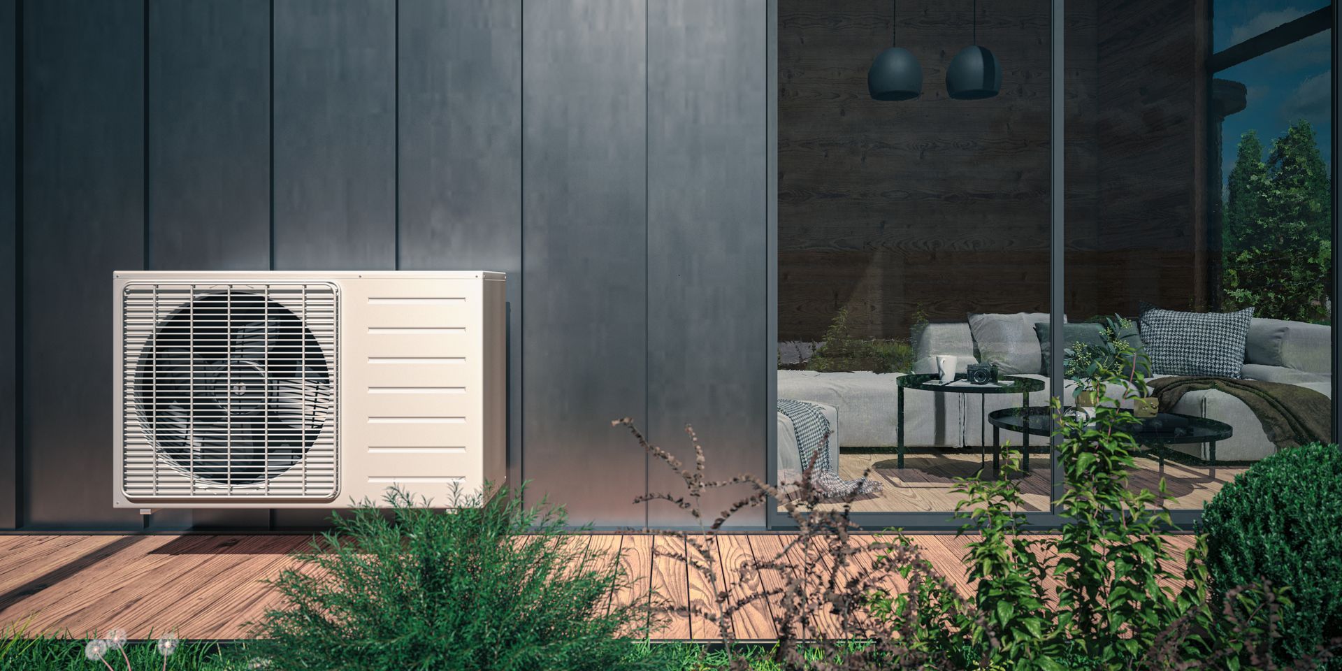 An outdoor heat pump unit sits on a wooden deck next to a modern home with glass doors and an interior lounge area. An outdoor heat pump unit sits on a wooden deck next to a modern home with glass doors and an interior lounge area.
