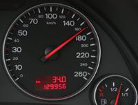 A close up of a speedometer on a car dashboard.