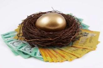 A gold egg is sitting in a nest on top of a pile of money.