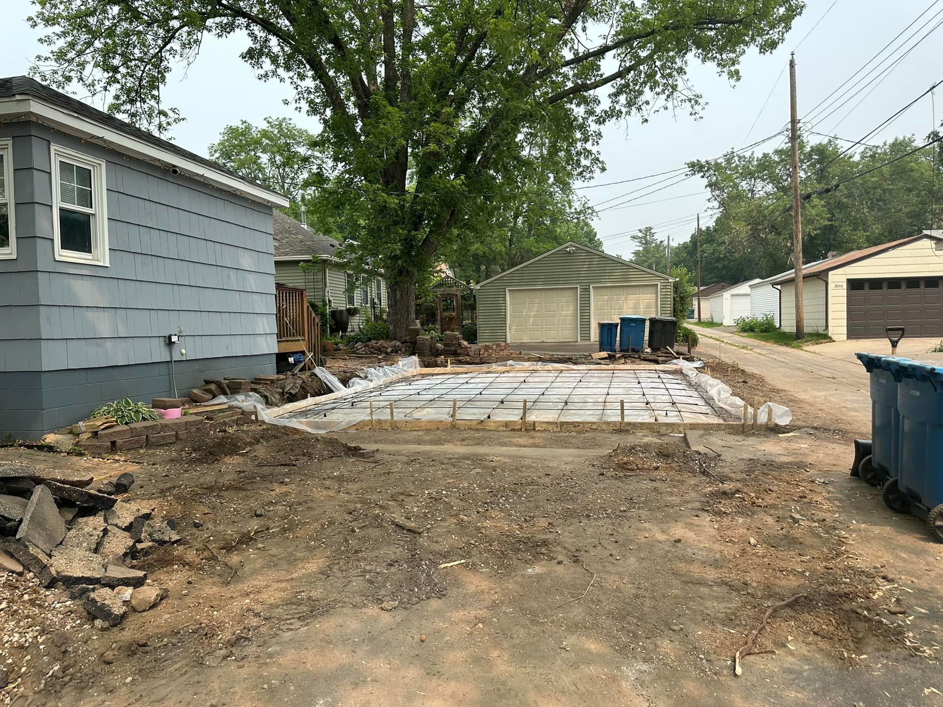 A house is being built in the middle of a dirt road.