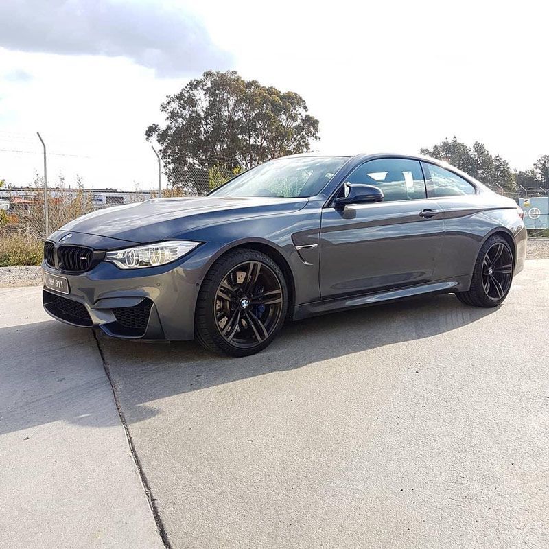BMW M4 Coupe is Parked on the Side of the Road — Powatone Exhaust Centre in Fyshwick, ACT