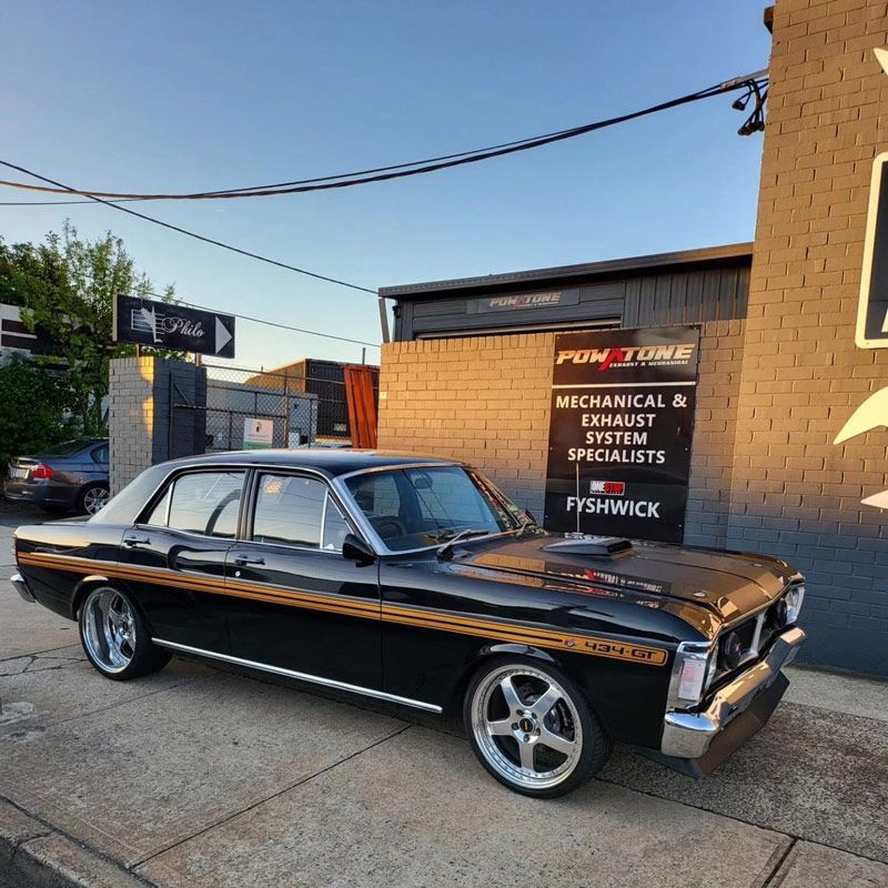 Black Classic Car is Parked — Powatone Exhaust Centre in Fyshwick, ACT
