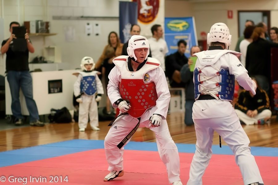 Two Karate Fighters Are Fighting on a Mat — Him-Do Tae Kwon Do Academy In Salamander Bay, NSW