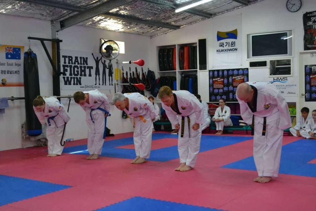 A Group of People Are Bowing in a Gym — Him-Do Tae Kwon Do Academy In Salamander Bay, NSW